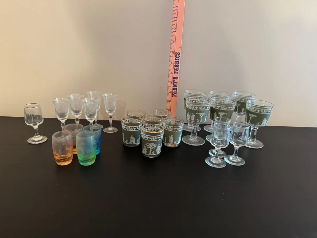 Assorted clear and coloured vintage drinking glasses