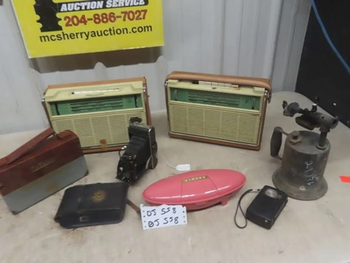 Vintage transistor radios, folding camera and brass torch